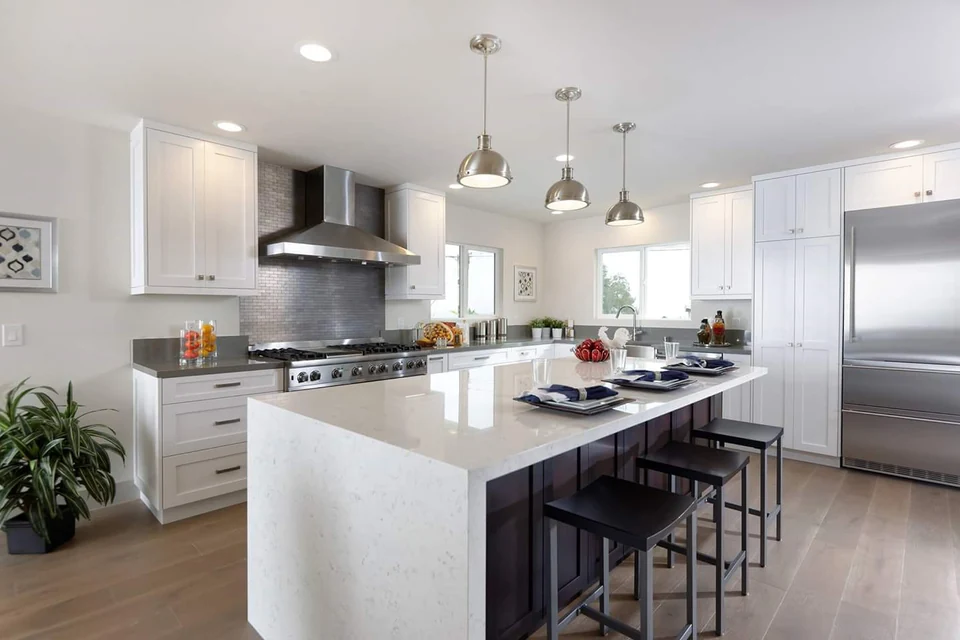 White stone kitchen island with bar seating in a San Diego home