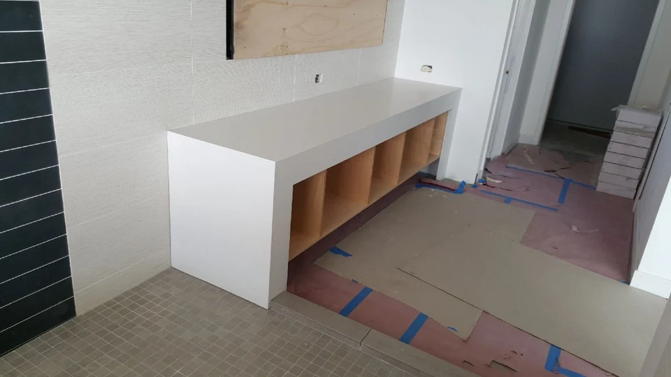 White waterfall counter set on a cabinet base